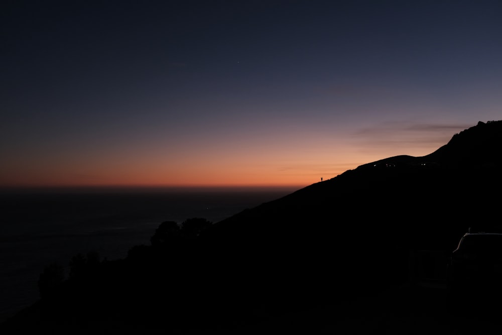 silhouette photo of mountains during golden hour