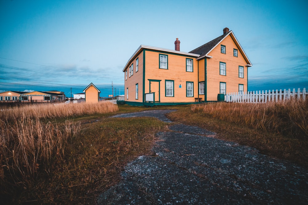 brown wooden house surrounded with green grass