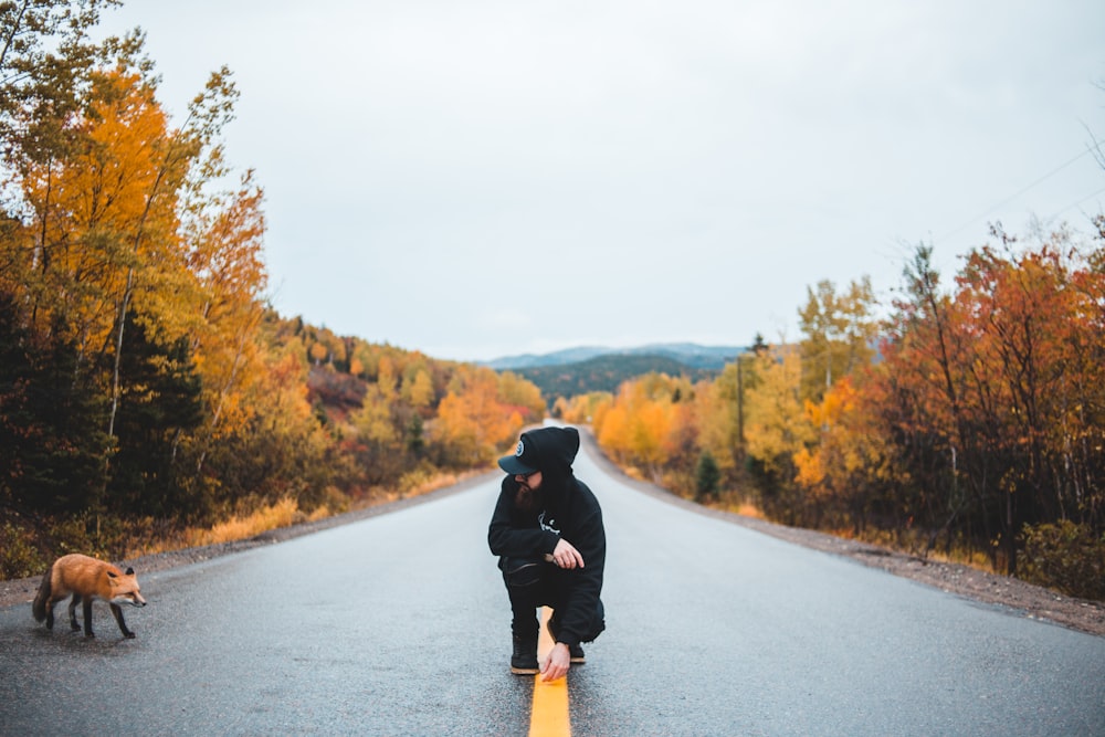 person siting between road