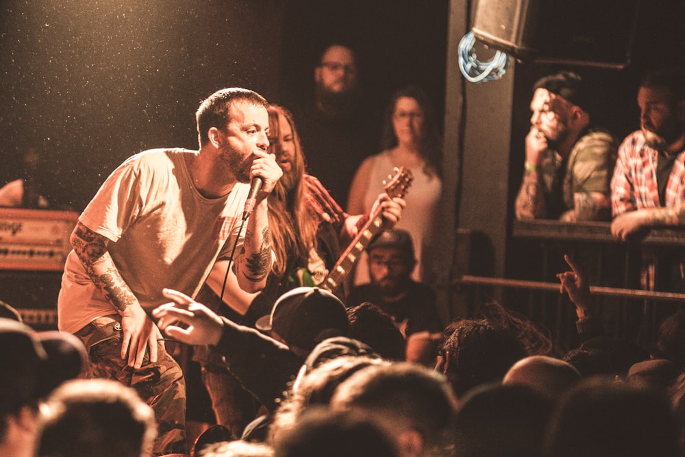 man singing on stage