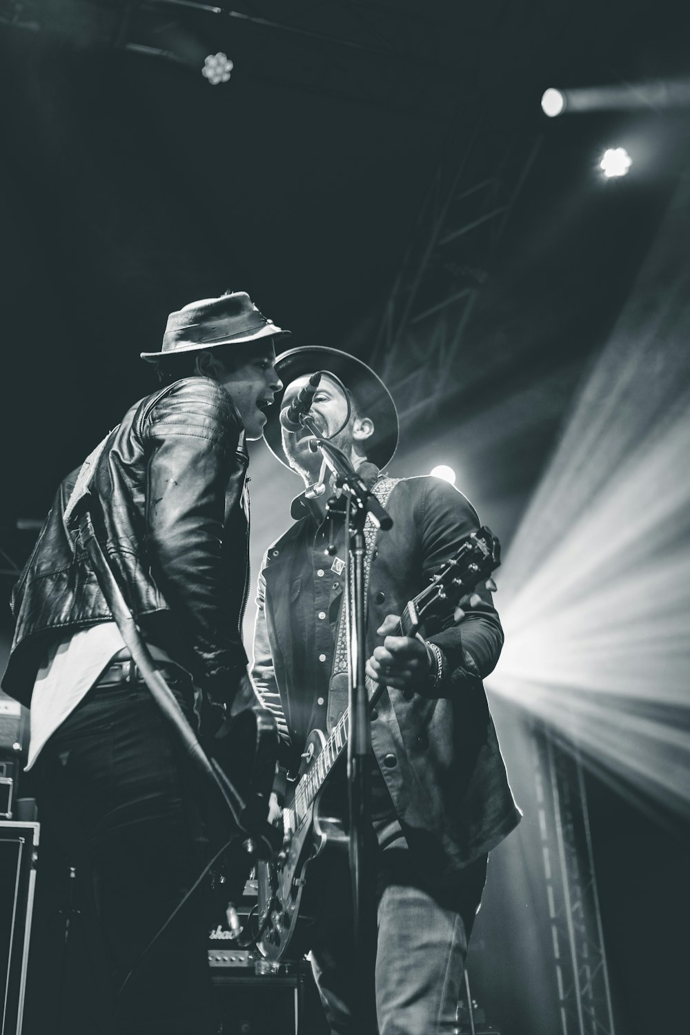 two men singing on stage