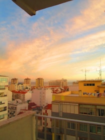 Balcony view from a Marrakech apartment showing bustling streets and colorful rooftops.
