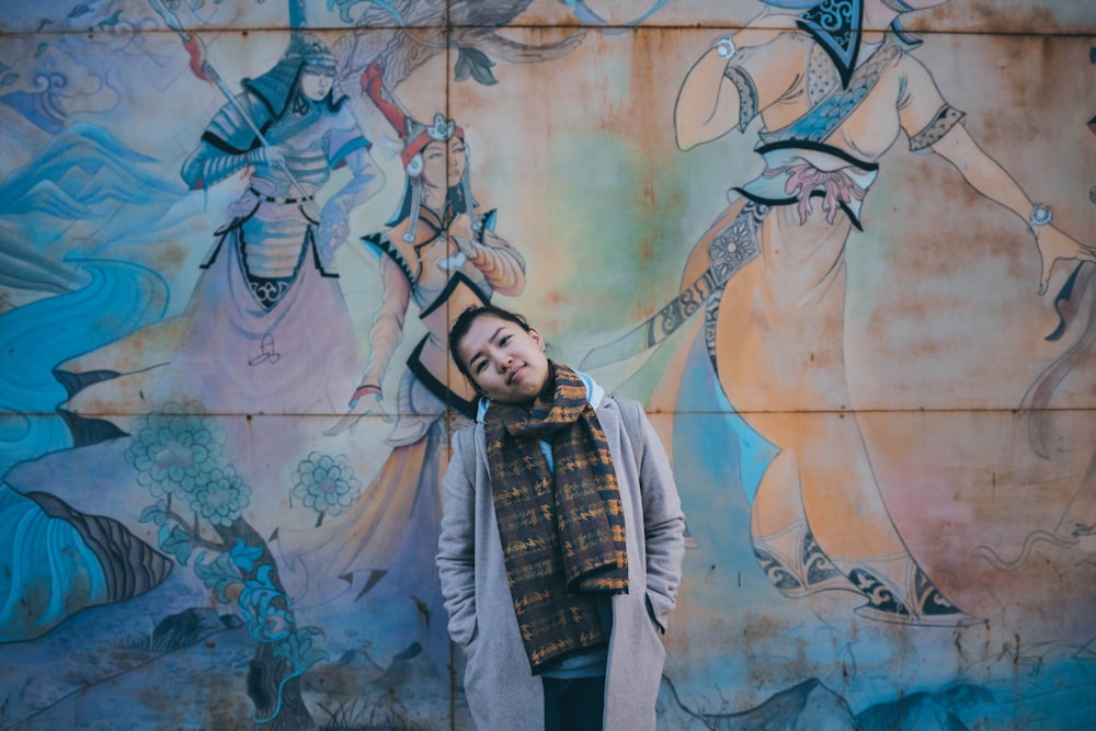 a man standing in front of a colorful wall