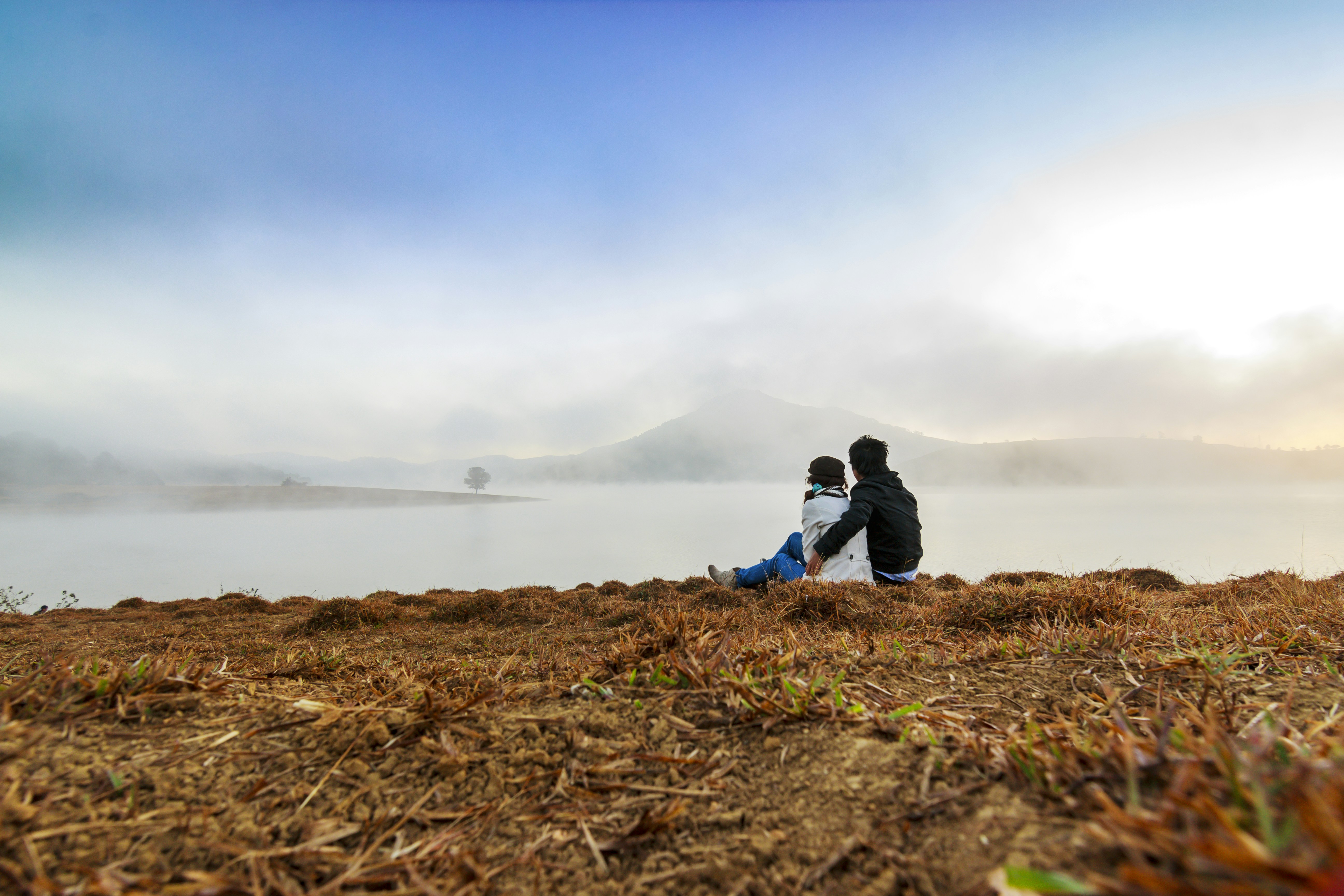 person sitting on brown grass field