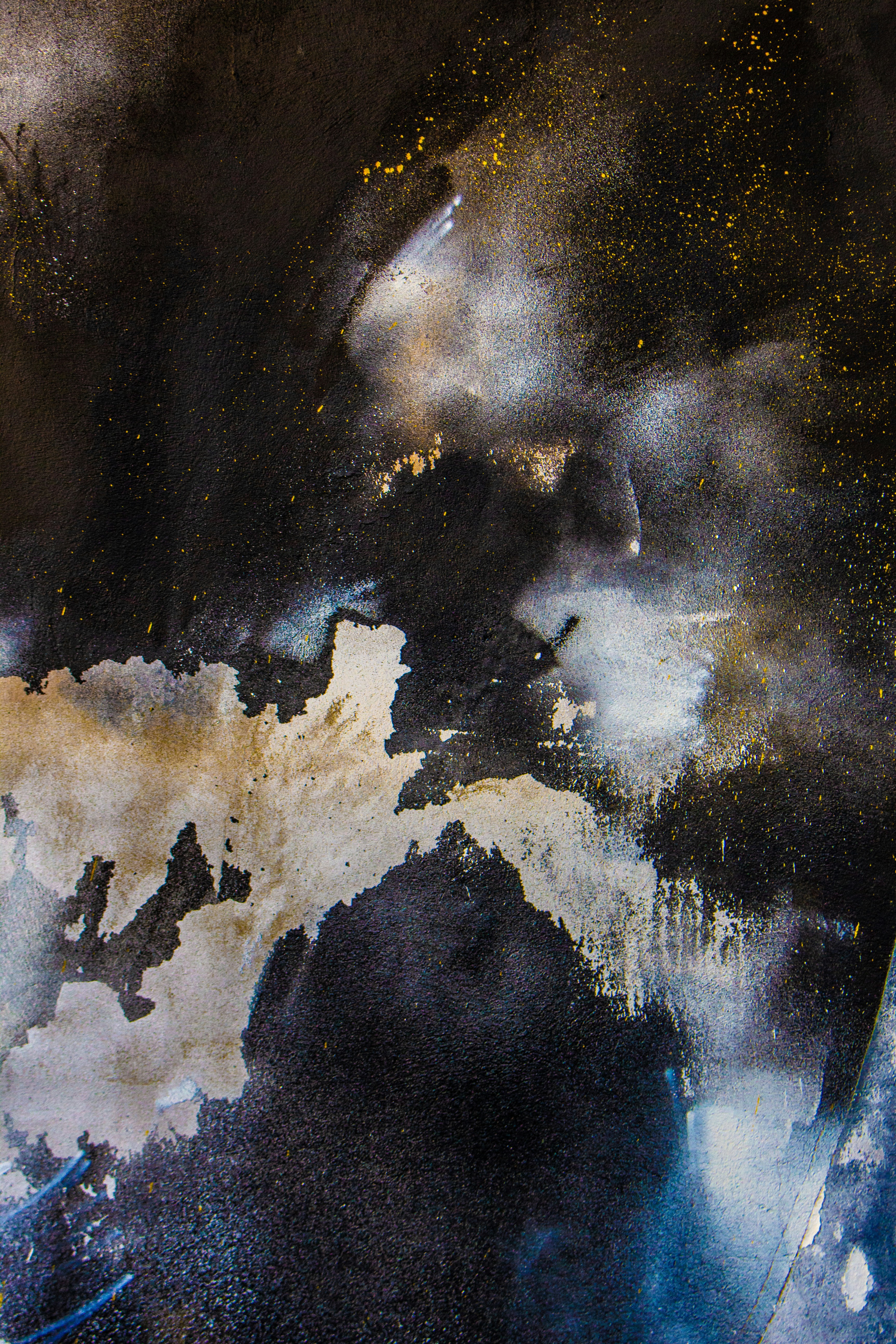 a black and white painting with gold flecks