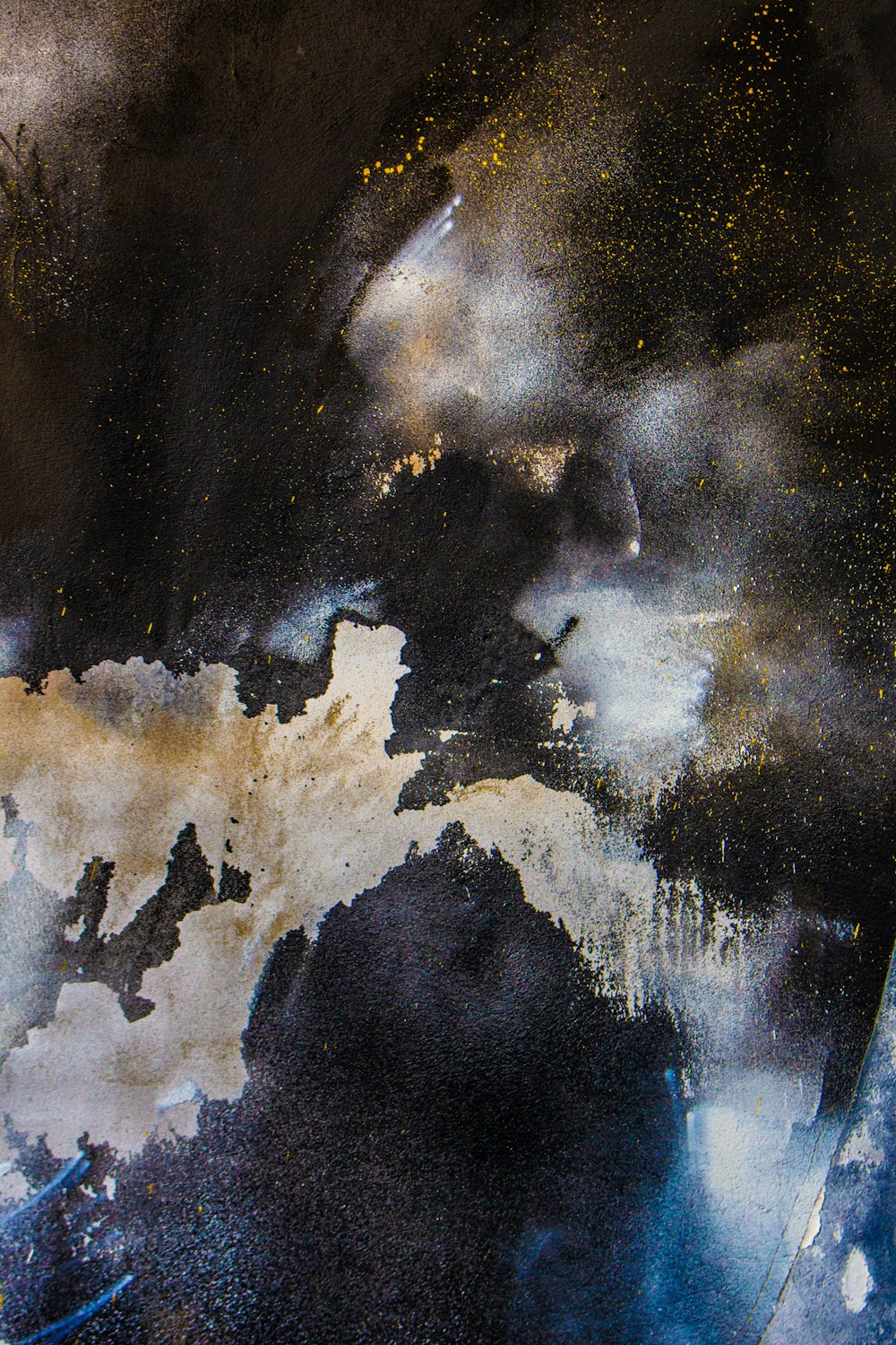 a black and white painting with gold flecks