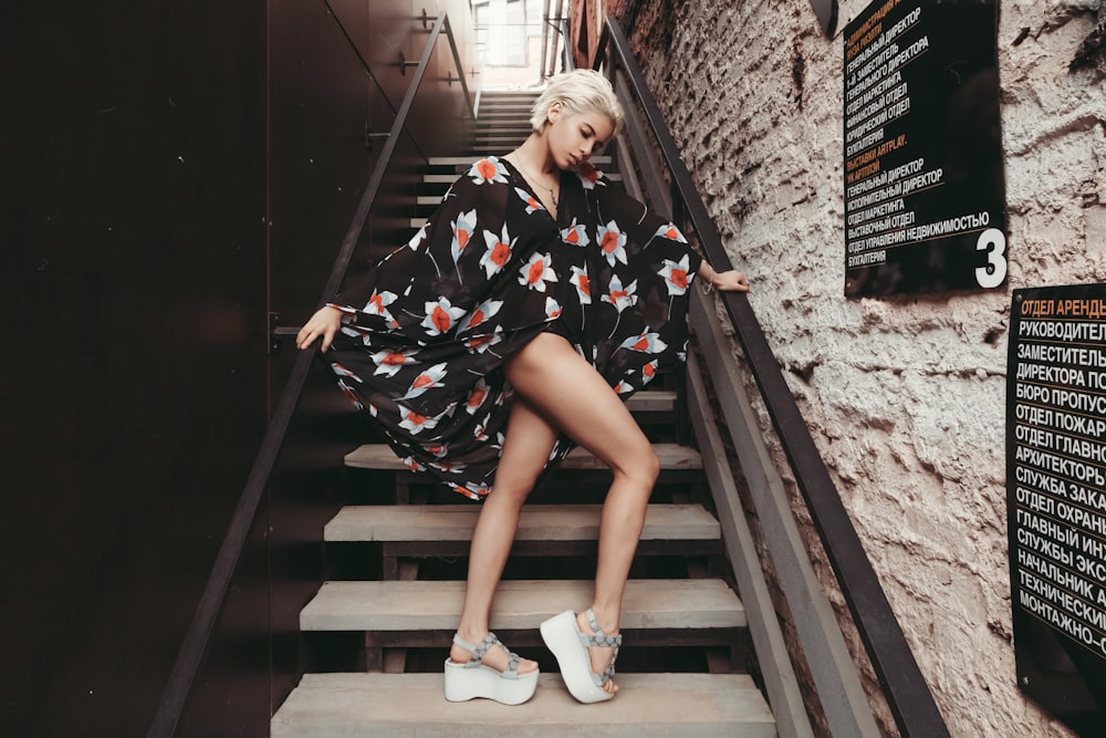 woman standing on staircase during daytime