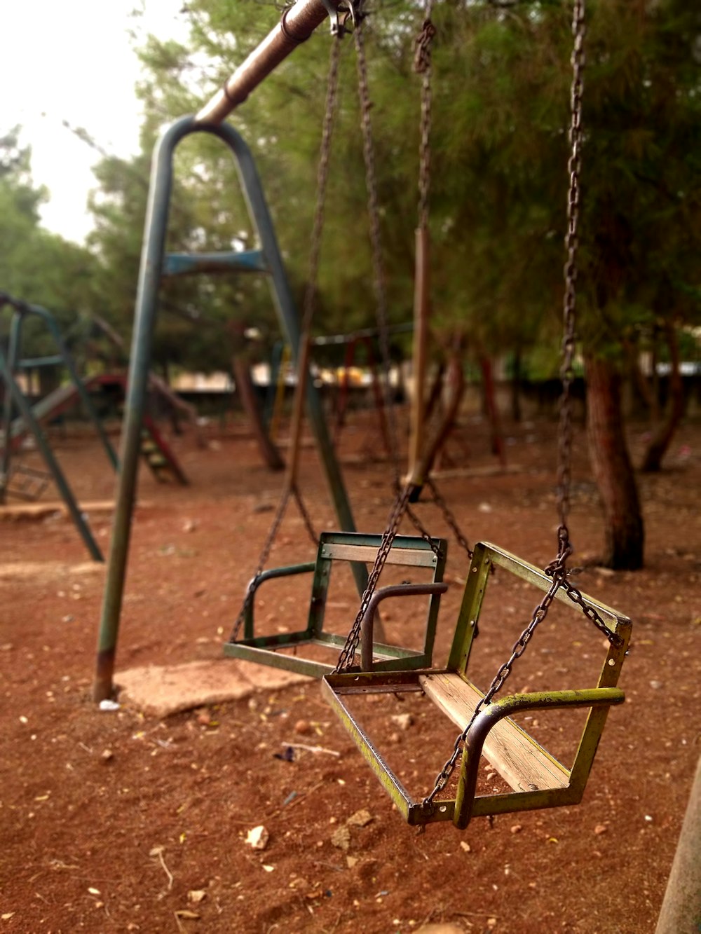 green and brown swing playground