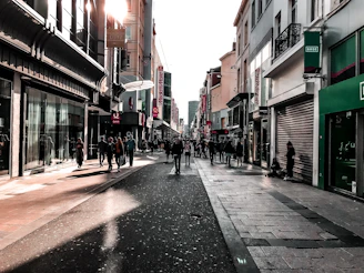 Street-level view of vibrant ground floor retail shops with modern glass facades and bustling foot traffic.