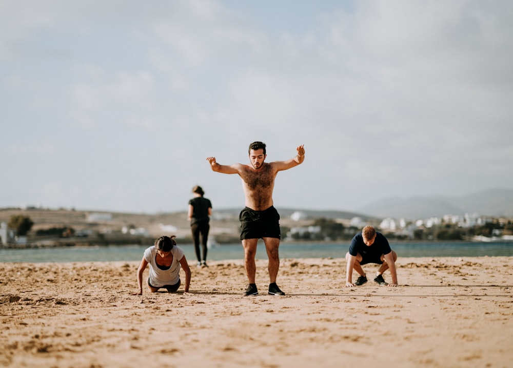 people doing exercise on beach front