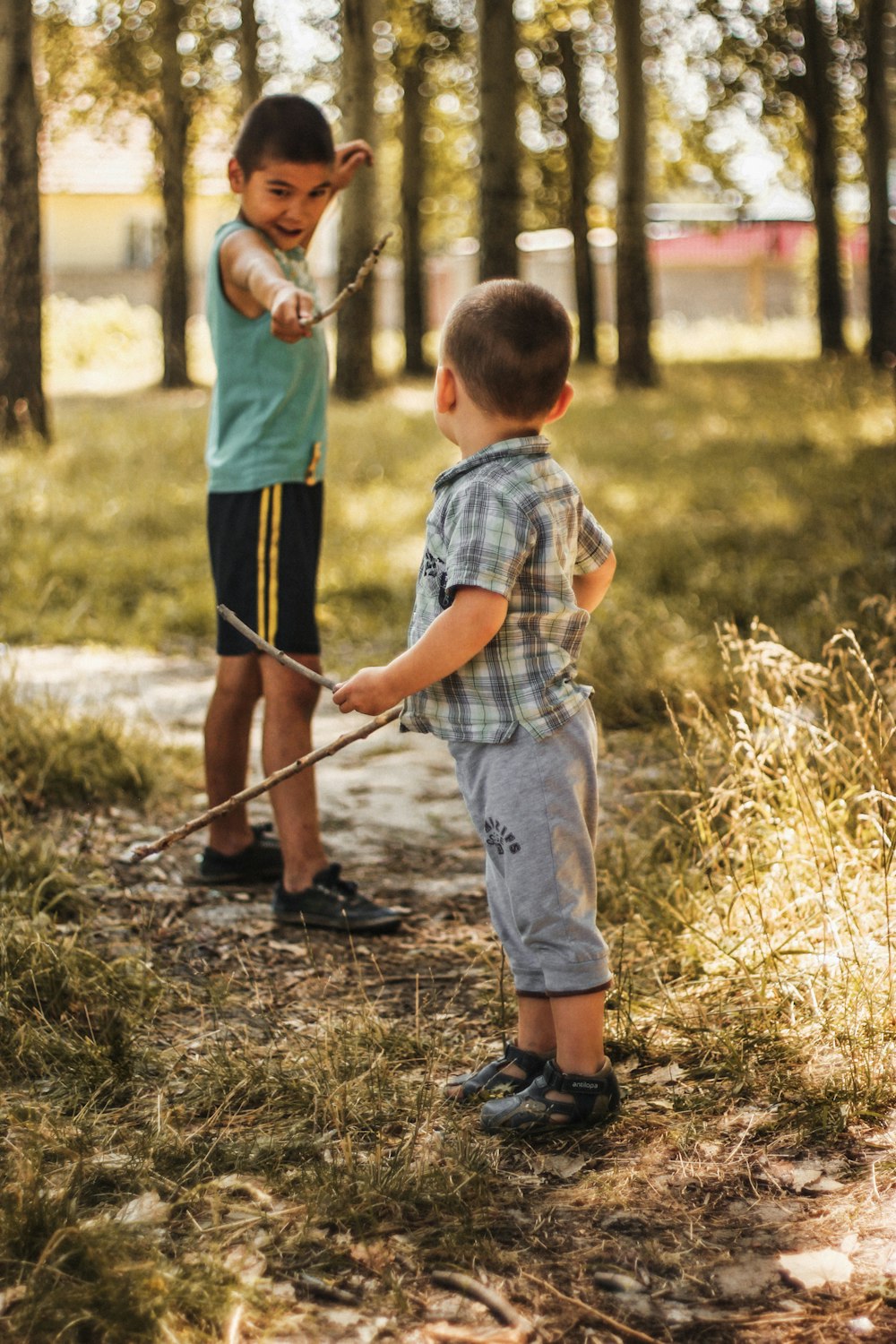 two boys playing sticks