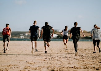 people running on seashore