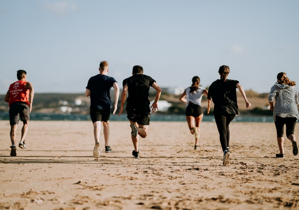 people running on seashore