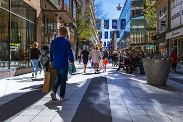 people walking in between buildings during daytime