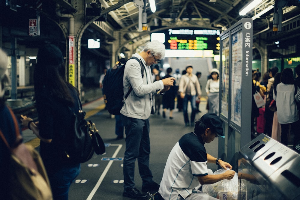 people standing at train station