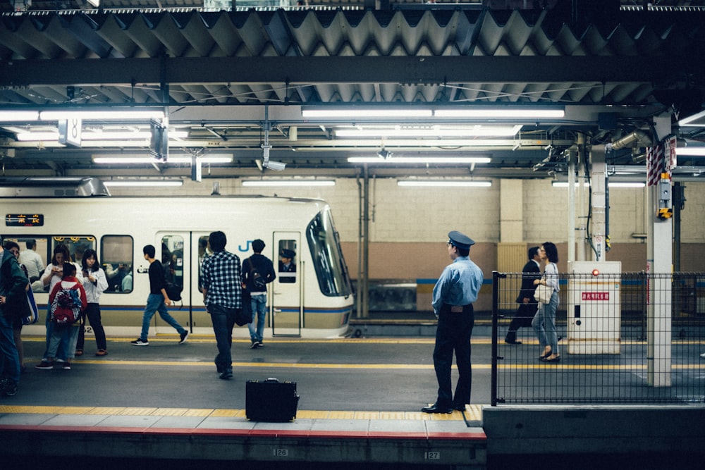 people standing near white train