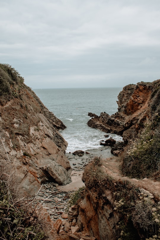 pathway between rock cliffs leading to the sea in Groix France