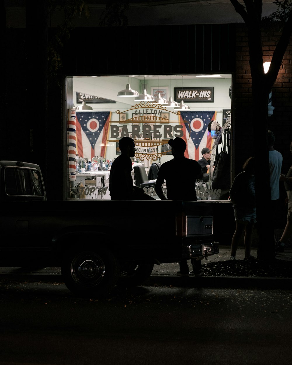 turned-on lights of Clifton Barbers barber shop