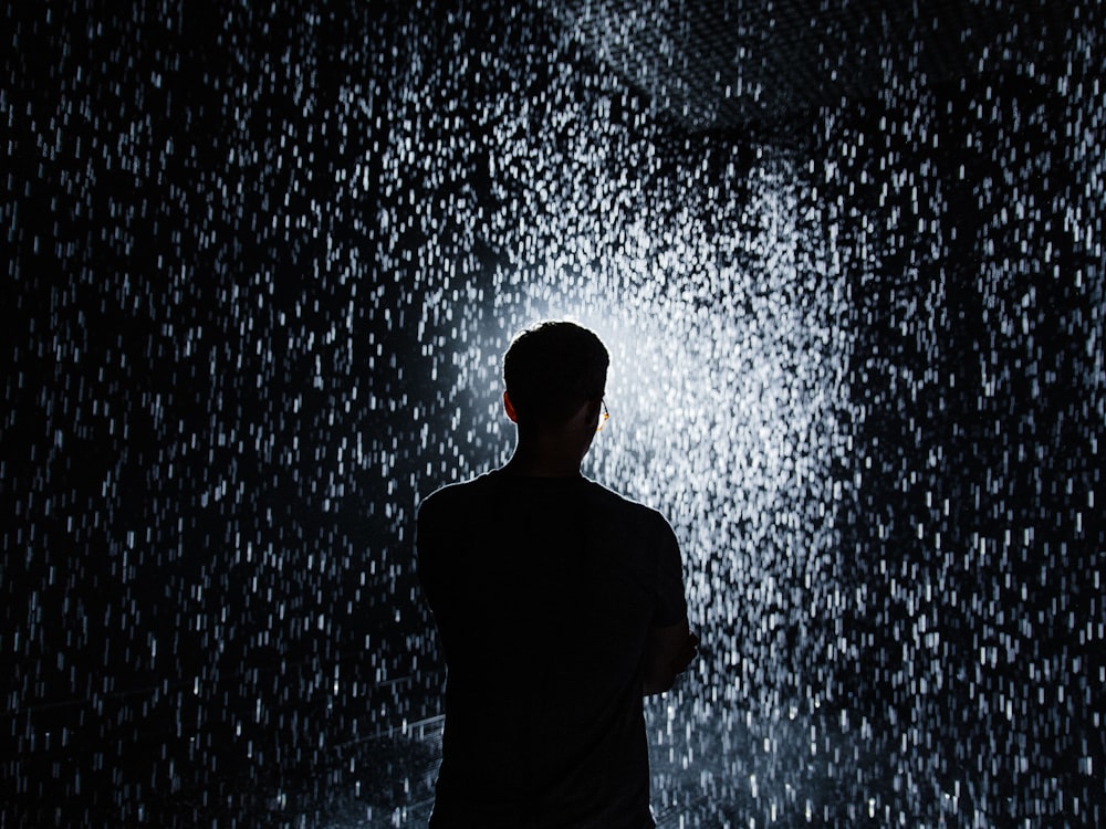 silhouette of man standing during nighttime