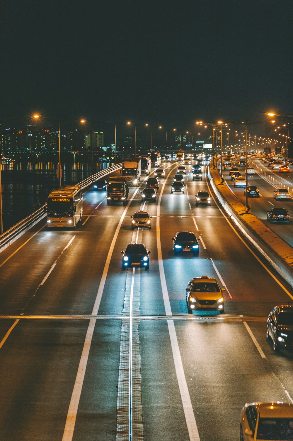 vehicles traveling on concrete road at night time