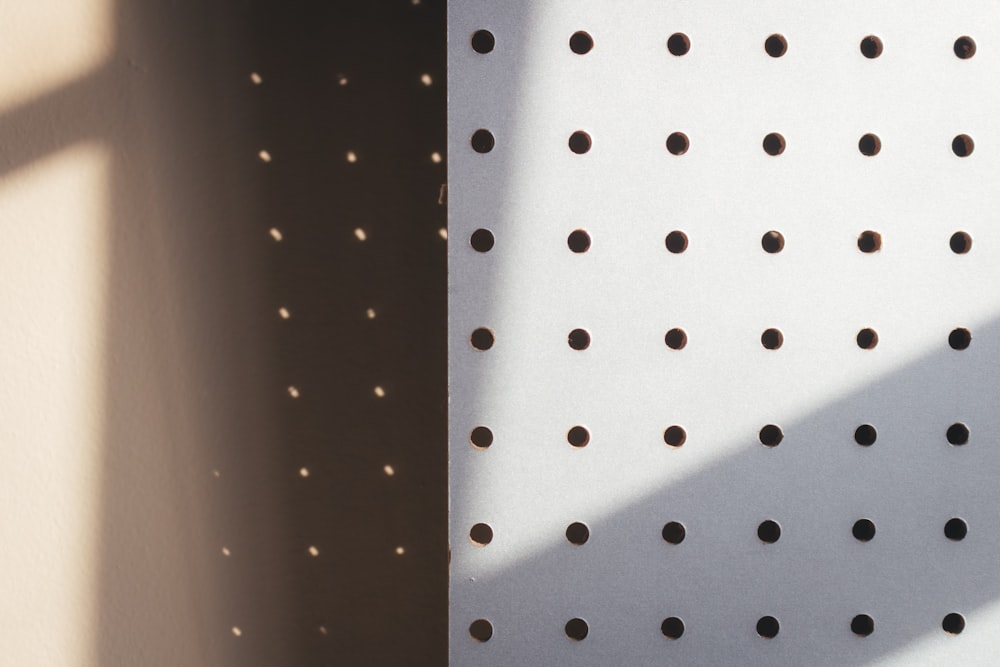 a close up of a wall with holes in it