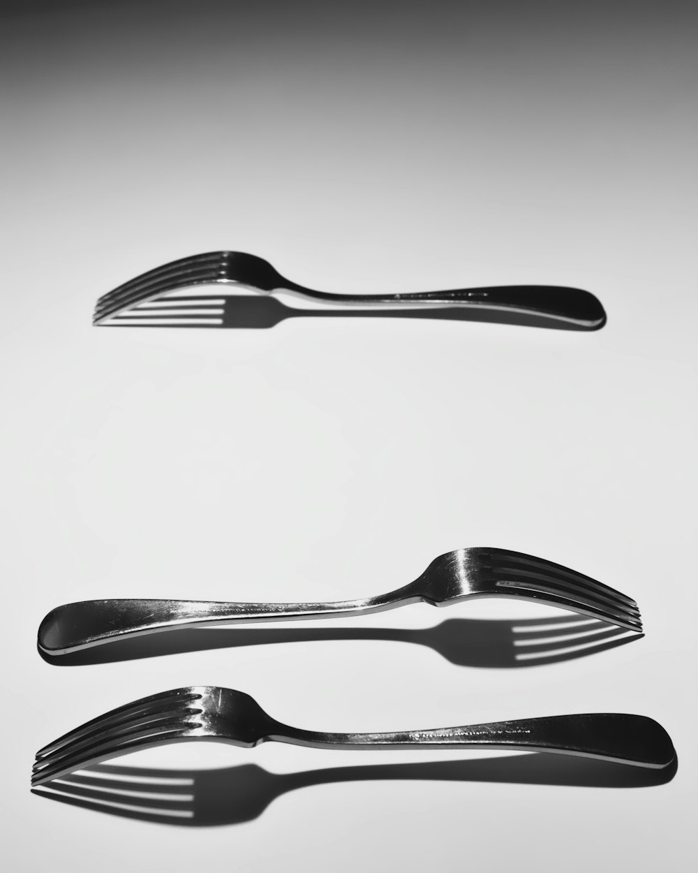 three stainless steel forks