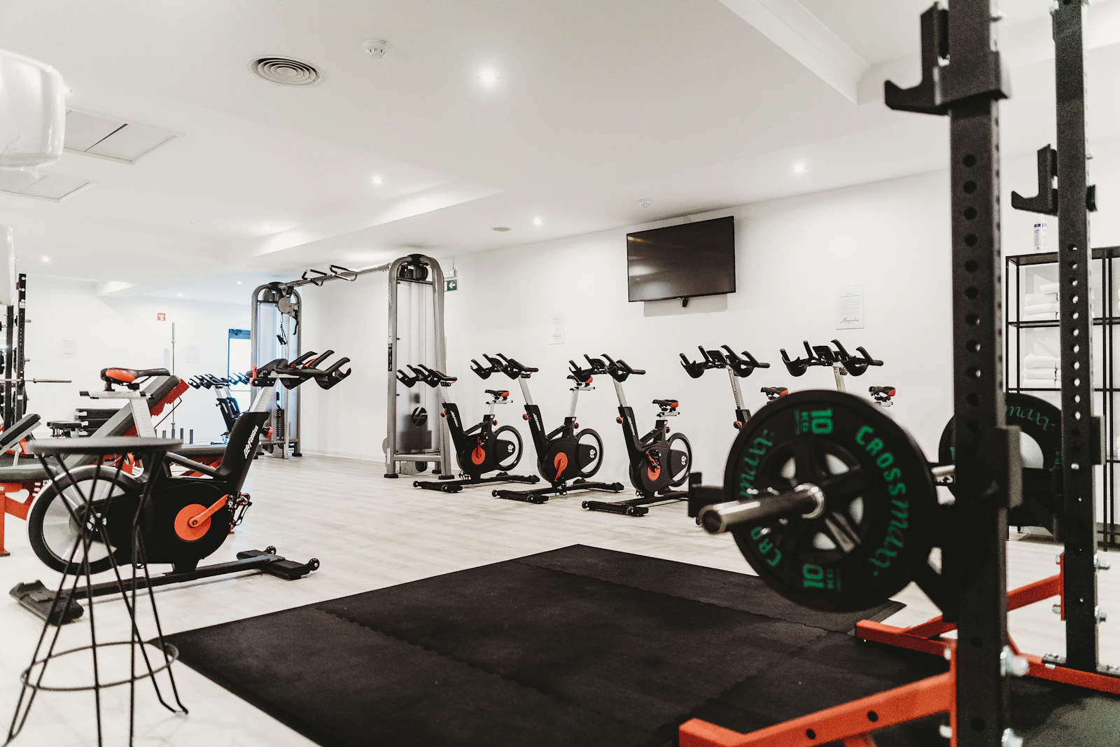 Clean gym space with training machines and fitness equipment