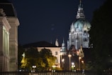 Nighttime view of Vilnius Cathedral illuminated against the dark sky.