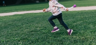 girl running on green field