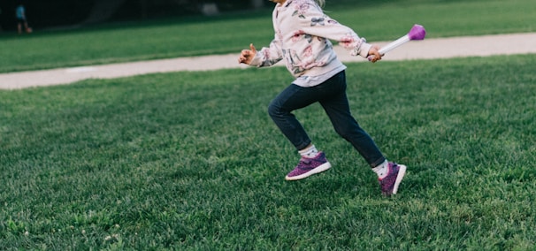 girl running on green field