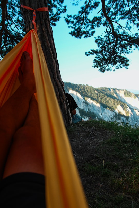 person in yellow hammock during daytime in Rheinschlucht Switzerland