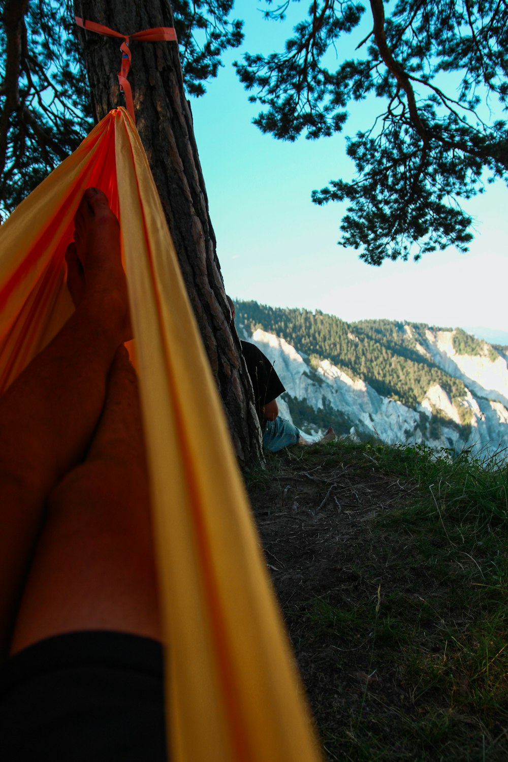 person in yellow hammock during daytime