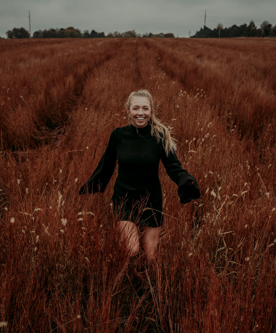 woman standing on brown grass field