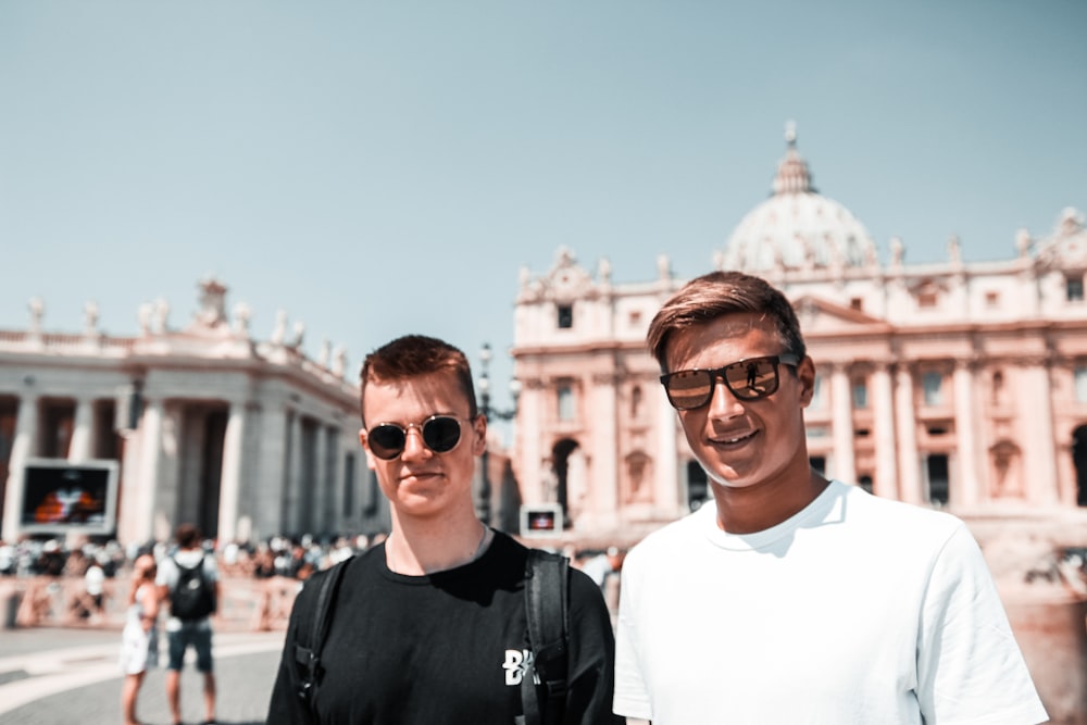 man standing beside man in black shirt