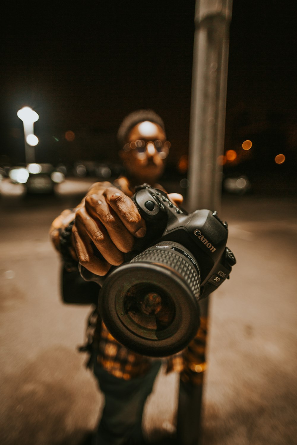 man holding black Canon DSLR camera