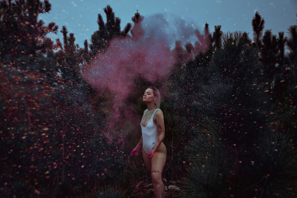 woman standing beside green leafed plant