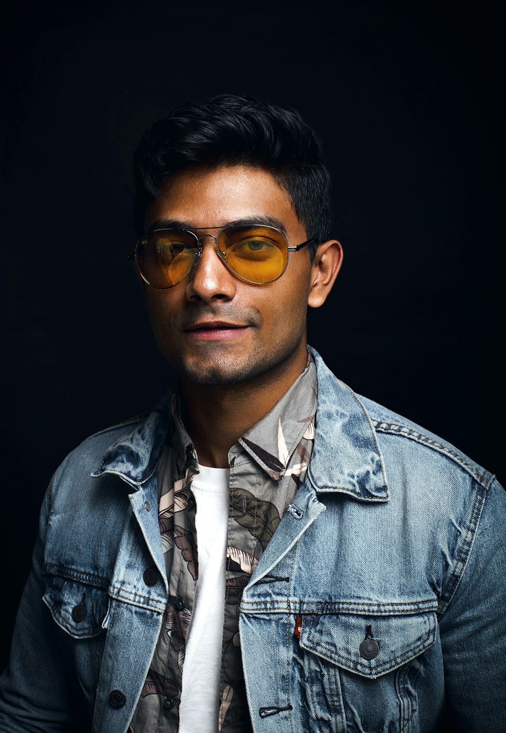 man wearing blue denim jacket