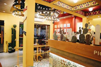 Warm interior of Sabor Maya restaurant featuring minimalist design and terracotta accents.
