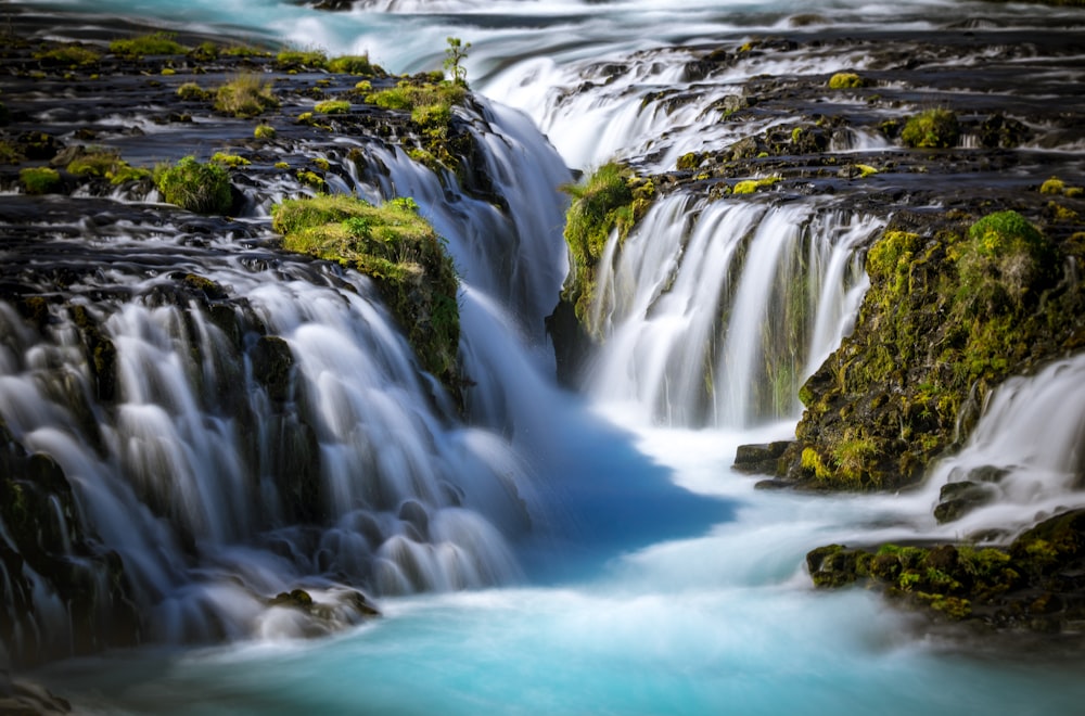 time lapse photography of flowing multi-tier waterfall