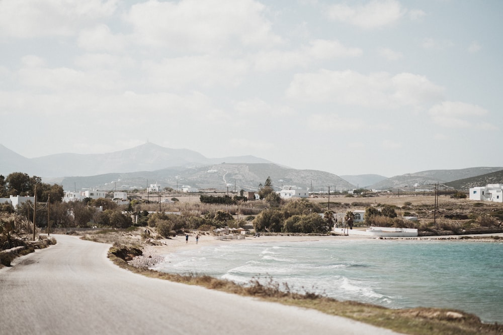 gray concrete road beside beach