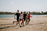 men and women running on sea shore