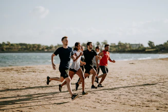 men and women running on sea shore