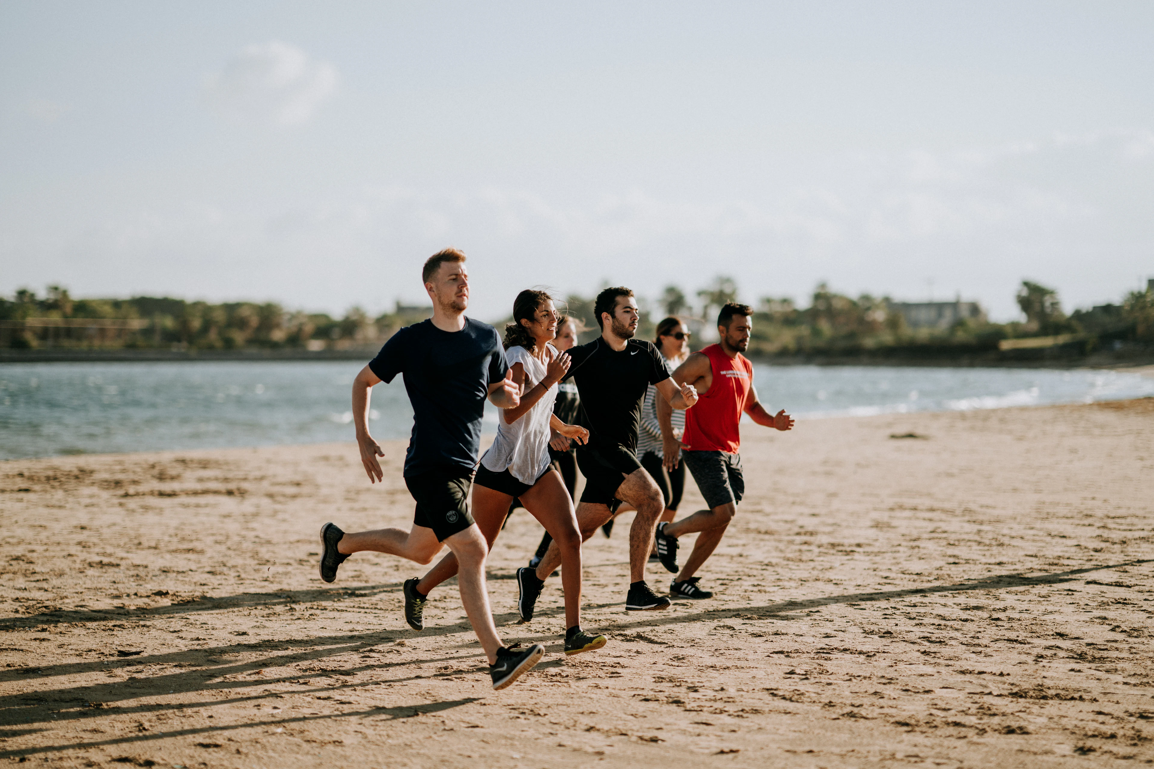A group of runners on the shore