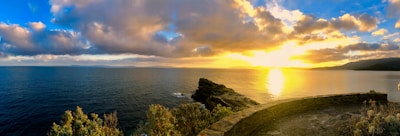 A panoramic view of Isla Isabel’s rocky coastline under a golden sunset.