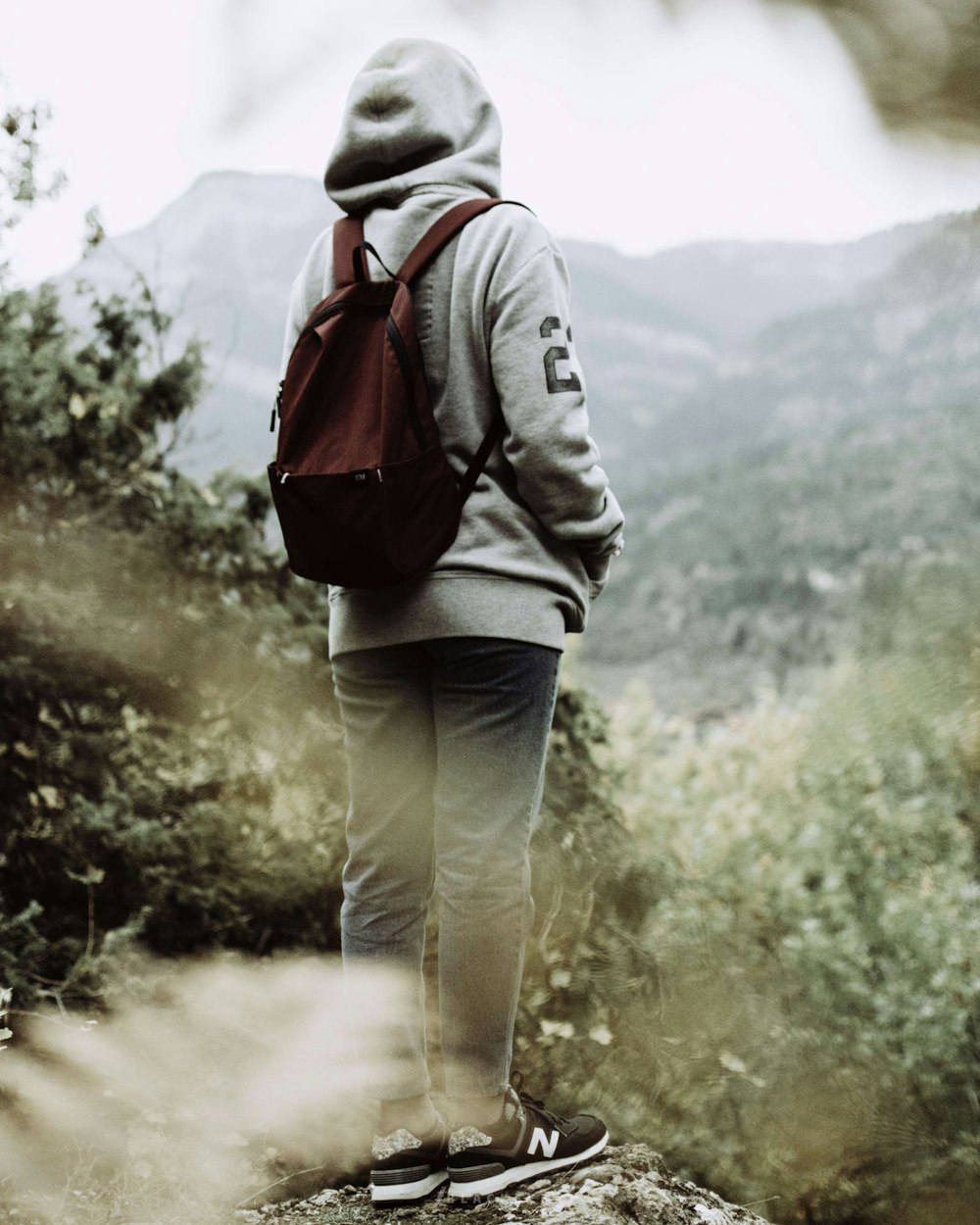 person wearing gray pullover hoodie and pants outfit