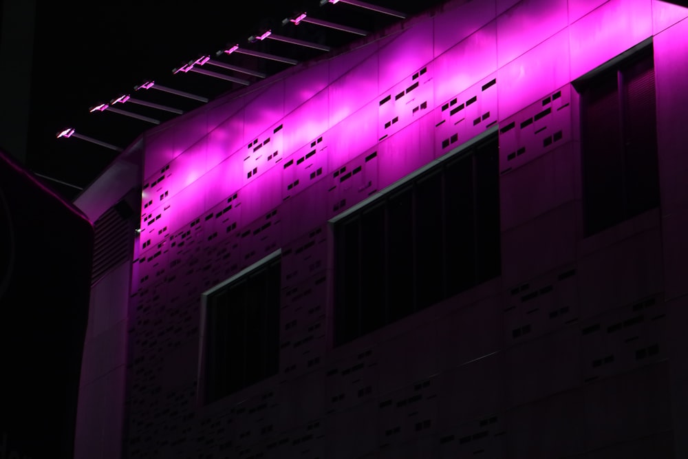 a building with a purple light on the side of it