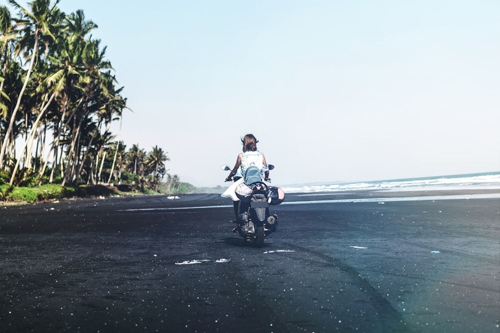 person riding on motorcycle near ocean