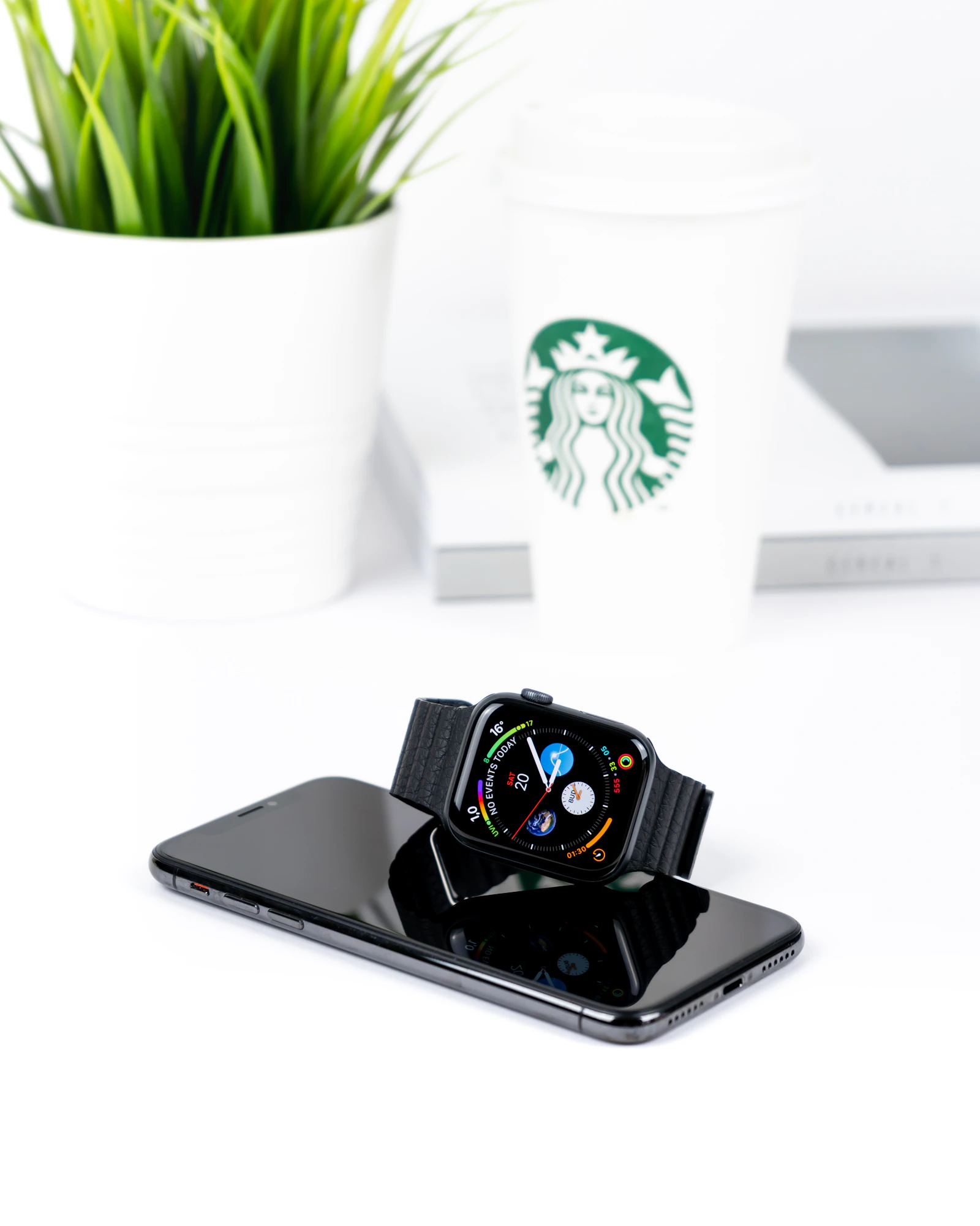 Smartwatch positioned directly on top of a smartphone