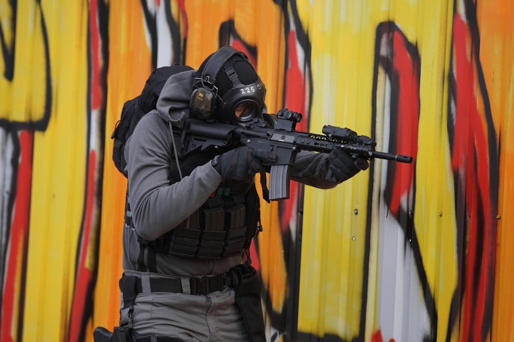 man in full gear holding gun