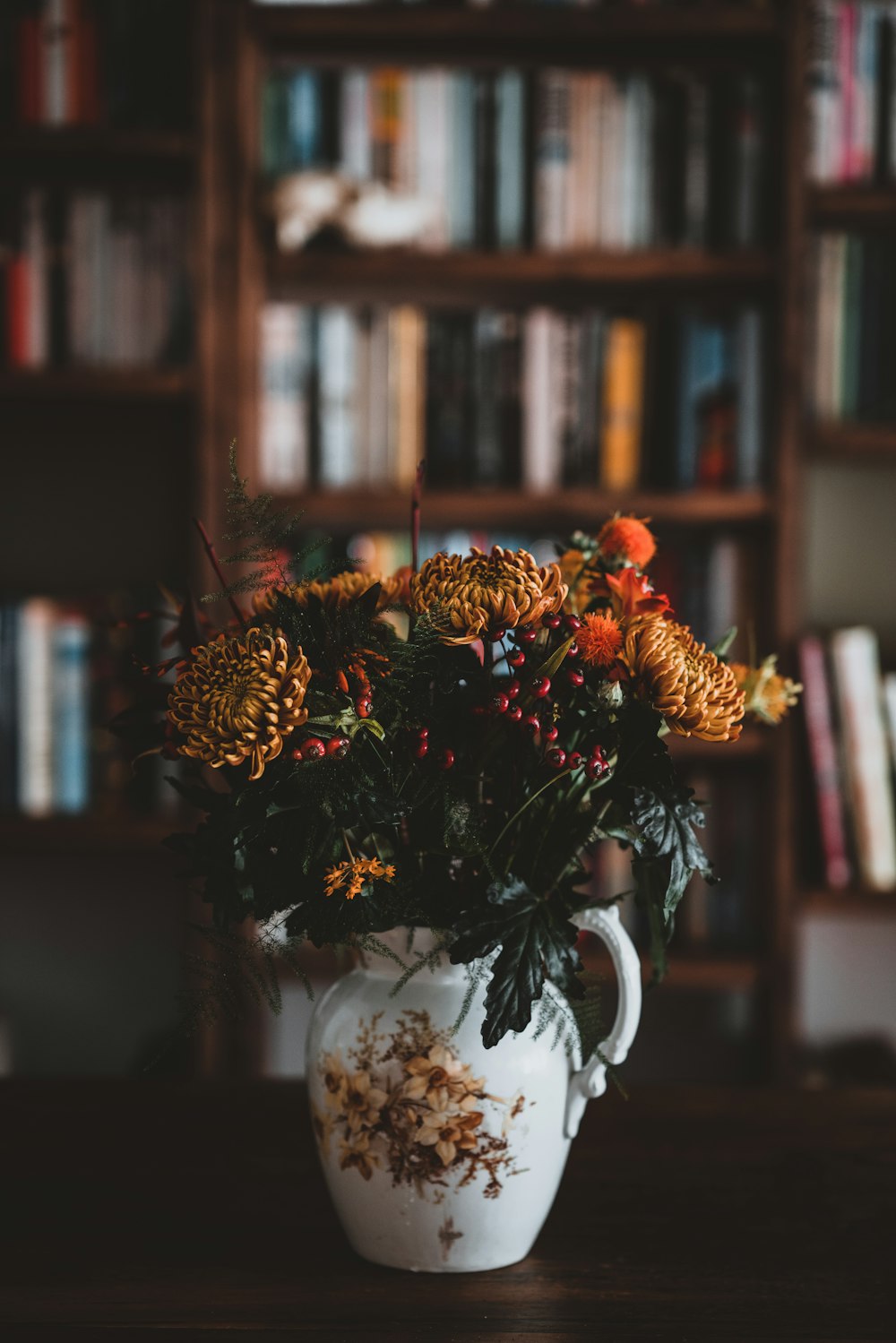 brown petal flowers in white ceramic vase